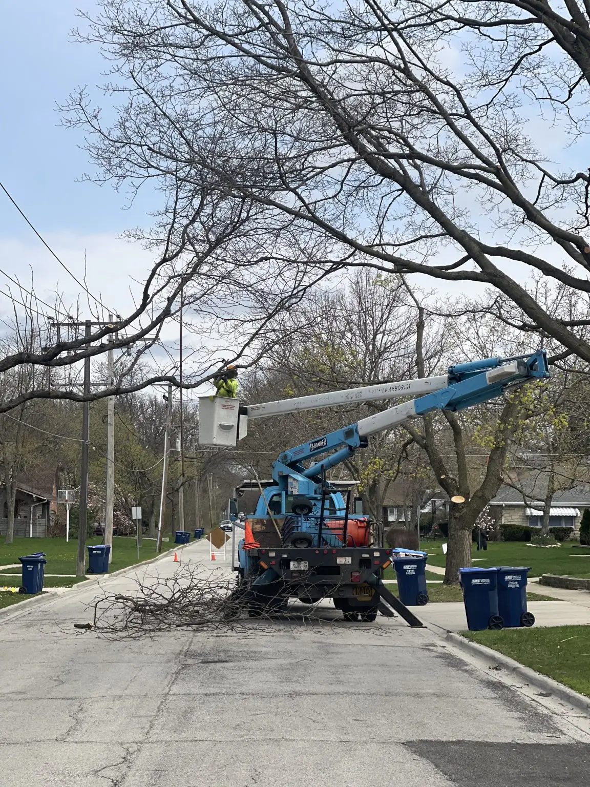 Storm damaged branch removal over garage by Winkler Tree and Lawn Care in Western Suburbs Illinois